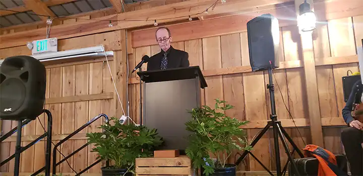 officiant speaking at celebration of life Geoffrey C Morell in barn