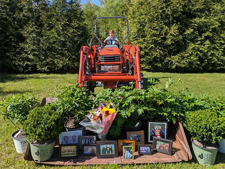 event celebration of life Geoffrey C Morell tractor in field images of Geoffrey and flowers